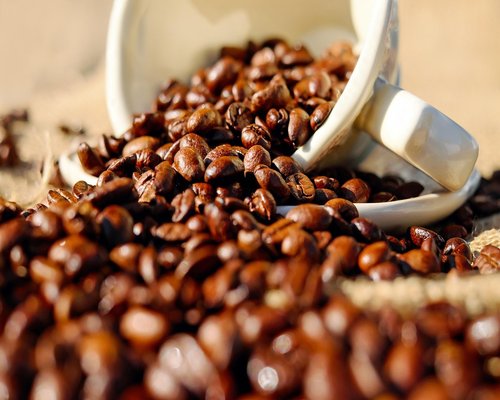 A glass of fresh water next to a cup of morning Colombian coffee